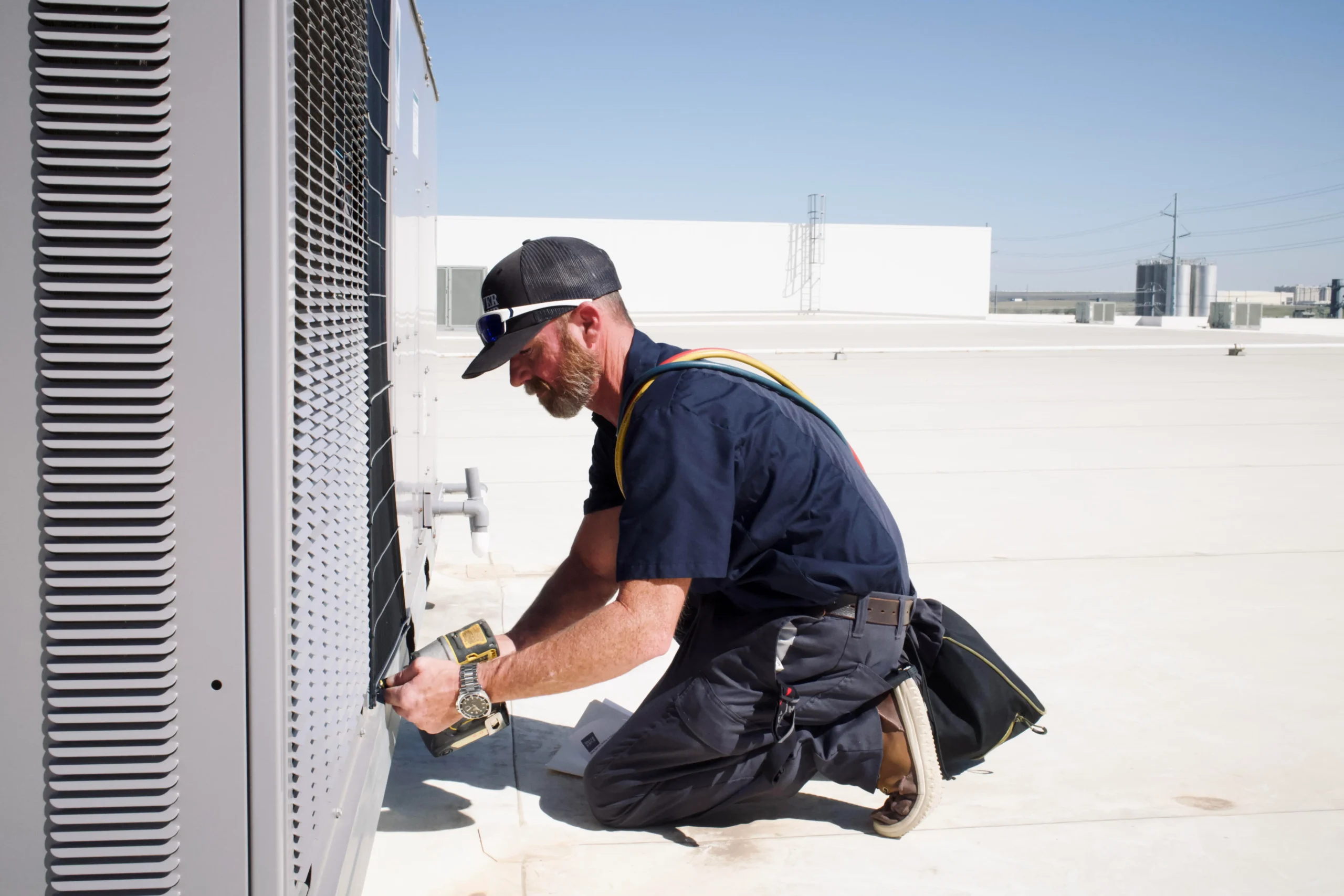 Fort Worth HVAC technician working on rooftop unit